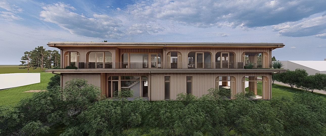 Modernes zweistöckiges Gebäude mit großen Fenstern und umlaufendem Balkon in einer grünen Umgebung